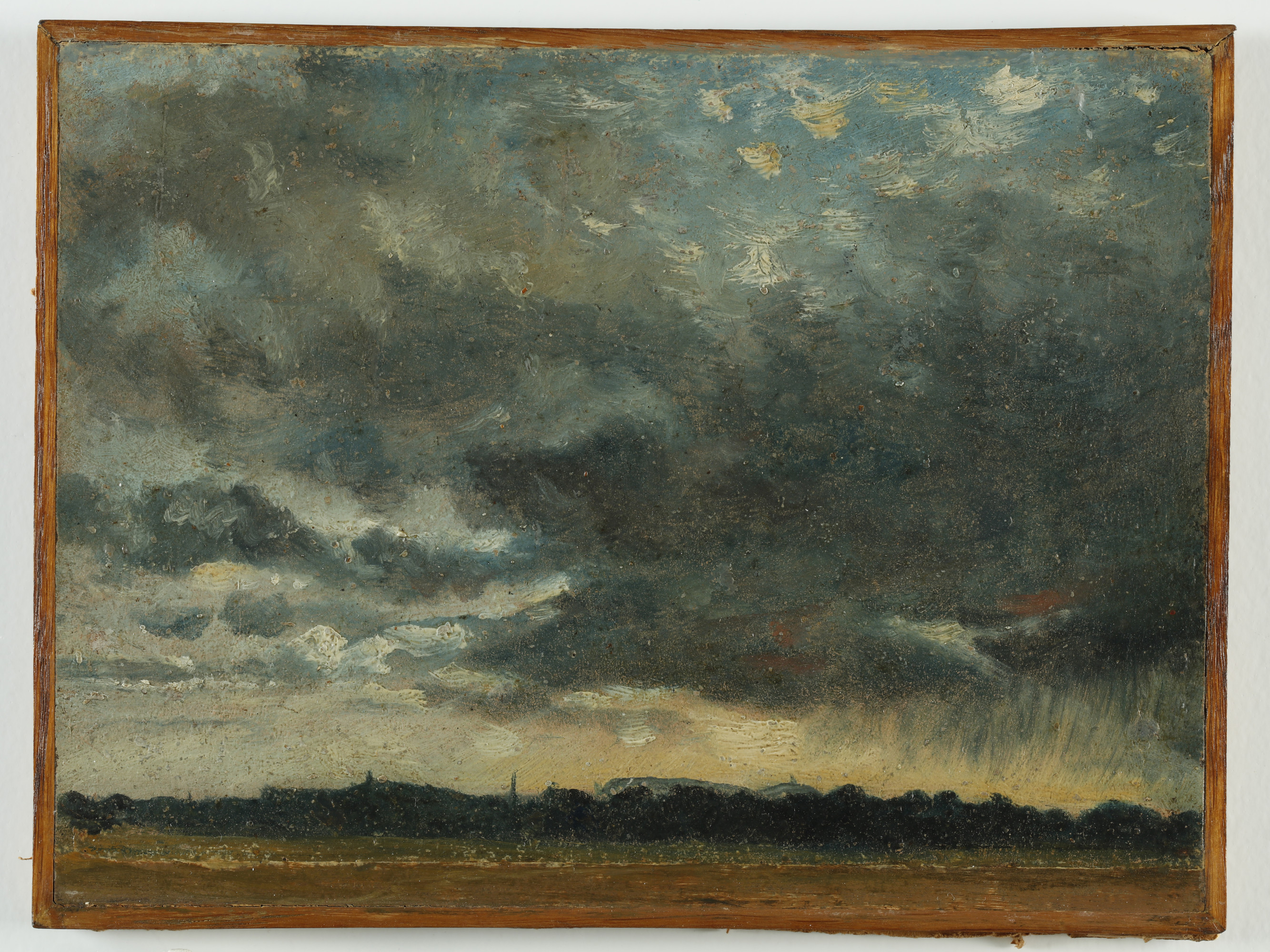 A landscape sketch in oils on paper with most of the picture devoted to a stormy sky and a strip of silhouetted trees