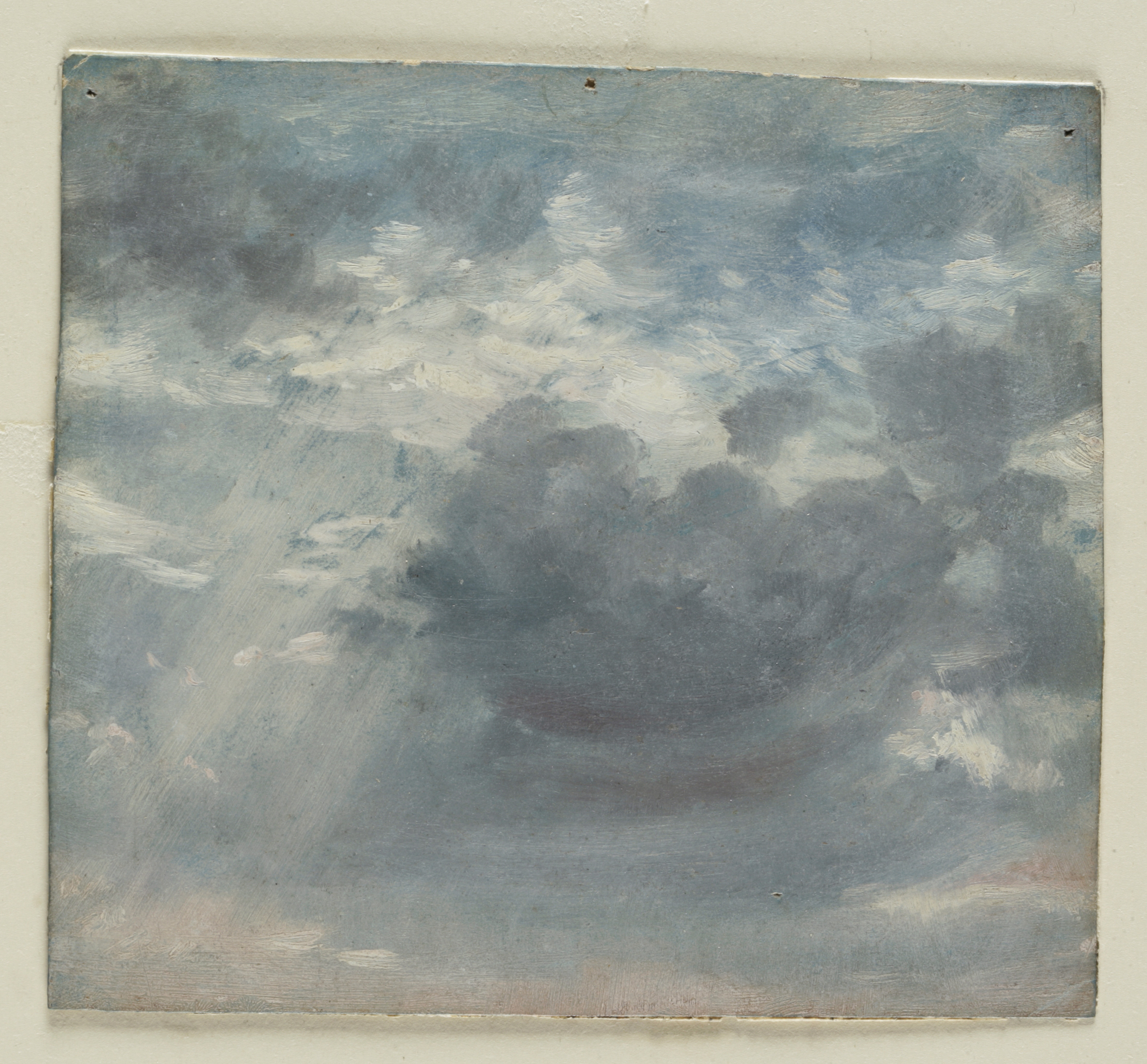 A sketch in oils on paper of a skyscape showing a shaft of sunlight emerging from behind a cloud
