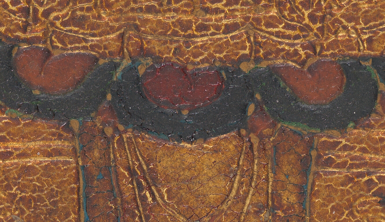 Detail of the surface of a panel showing alternating red and red-orange painted areas surrounded by black and gilded surface.