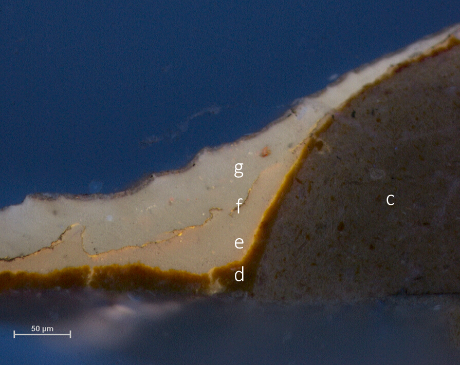 Microscope image of cross-section in UV showing white fluorescence in areas above and below a thin meandering line of gold leaf.